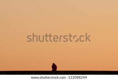 Single person relaxing at sunset