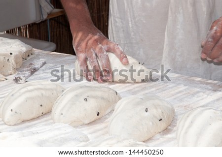 Baker worked in the dough for breads