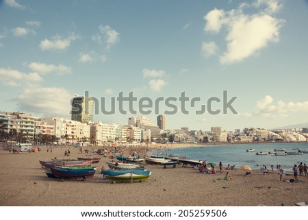 Las Palmas, Spain - September 4, 2012: Spanish families and tourists enjoying their day at the crowded beach of Las Canteras, the second longest city beach in the world.