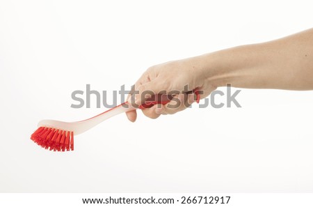 Hand holding dish brush on white