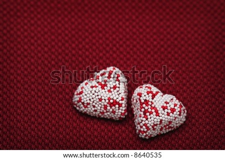 Valentine heart candy over red background 2