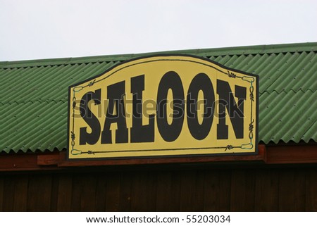 Old Saloon Sign on Weathered on green roof
