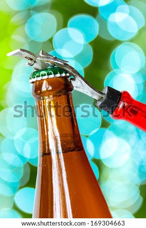 Opening dark beer bottle with metal opener