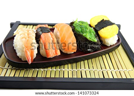 Mix Sushi on Black bamboo dish and Sushi is food of Japanese.