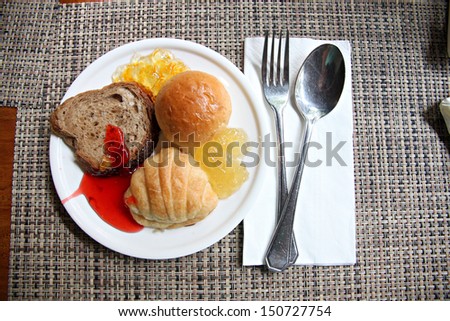 Bread and Jam in white dish of  breakfast.