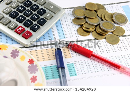 Image Design The Money and office equipment that is placed on businesses graph.