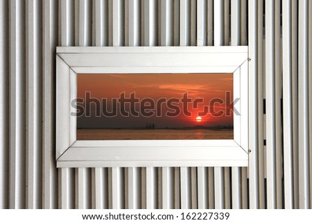 Aluminum windows on Aluminum Background and see the Picture of Sunset.
