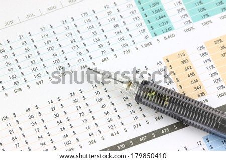 Mechanical pencil point to number on business graph.