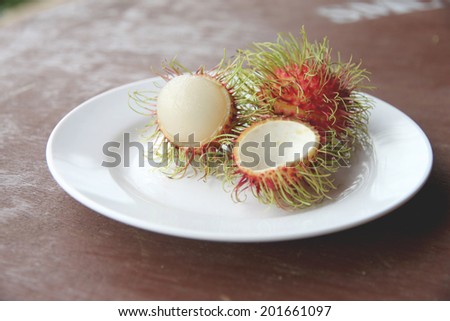 Fresh rambutan fruit of peeling in dish on the foods table.