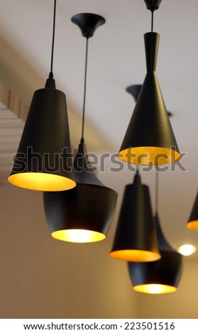 Modern black lamps on the ceiling of a residential house.