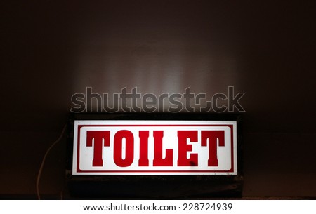 LED signs provide directional to the toilet.