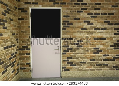 Door and brick wall in home interiors.