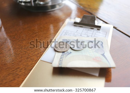 The money of Japan (Yen) and bill for meals on the table in a restaurant.