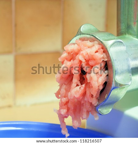 Chicken minced meat in a meat grinder