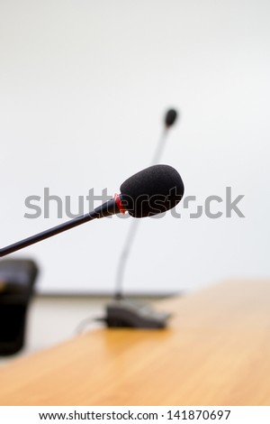 Microphone stands on meeting room table