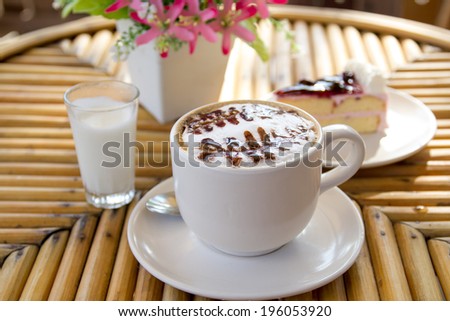 Cup of cappuccino coffee with cake