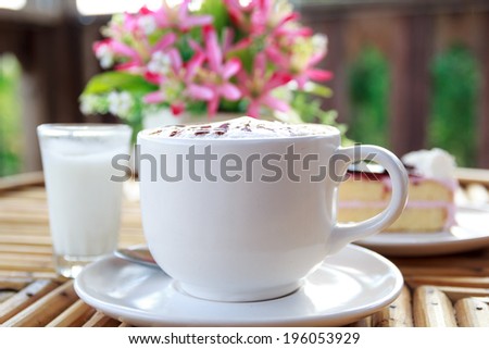 Cup of cappuccino coffee with cake