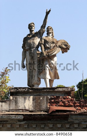 Typical old soviet dust and wrecking statue in recreation park. Worker and collective farmer.