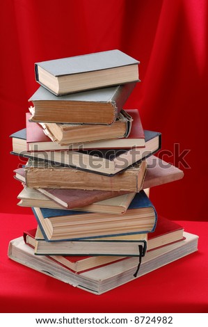 Pile of big books on the red background.