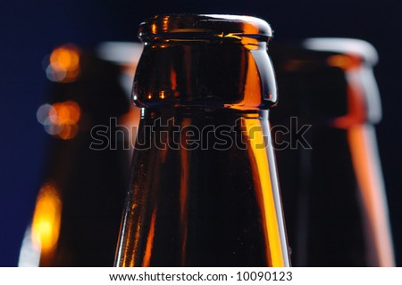 Close-up of the brown glass bottle necks. Narrow depth of field.