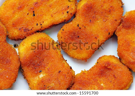 Hot and fresh chicken cutlets on the plate. Narrow depth of field.
