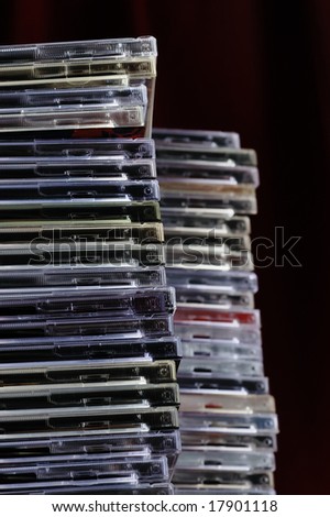 Big pile of old CD boxes. Used and dusty. Narrow depth of field.