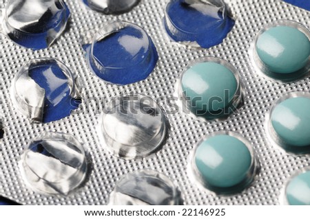 Partially used blue tablets. Close-up. Narrow depth of field.