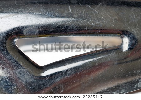 Stainless steel kitchen tongs isolated on the white background. Narrow depth of field. Fragment. Close-up.