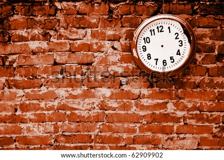 stock photo : Broken clock without hands on the brick wall.