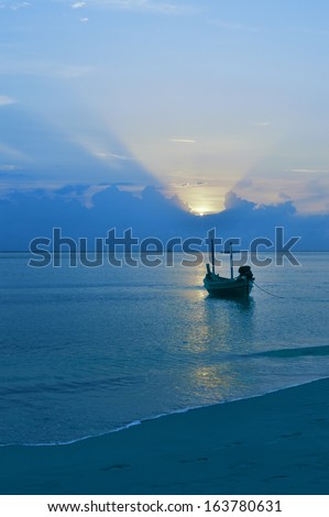 Boat in ocean under morning sun. Calm weather.