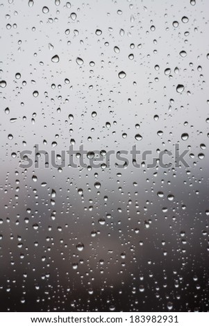 Raindrops on the window glass. In front of out of focus background.
