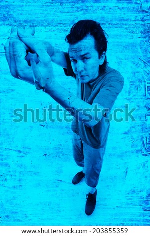 Working man with tool in his hands posing in the studio.
