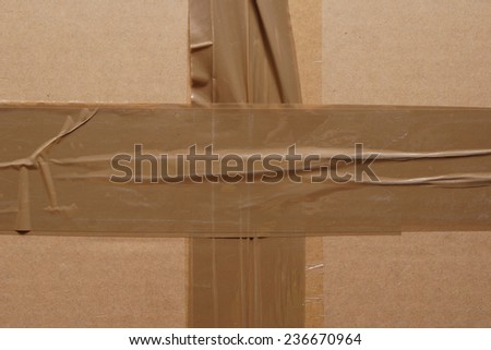 Brown cardboard box sealed with adhesive tape. Texture.