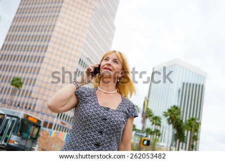 Close Up portrait happy smiling old senior business woman 60 years in the downtown talking with mobile phone, Lifestyle woman on smartphone, businesswoman calling on the phone in street