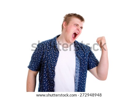 portrait of angry upset young man, worker, employee, business man in blue shirt with fist up at you gesture, isolated on white background. Negative human emotion, facial expression
