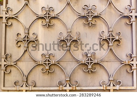Old Decorative textured metal lattice on a wall