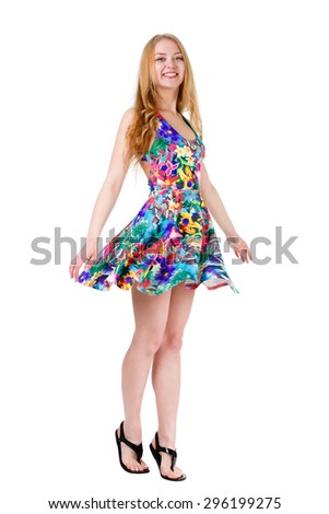 Full length of young cute smile girl stands on tiptoe in summer dress posing isolated on white background, positive human emotion, facial expression