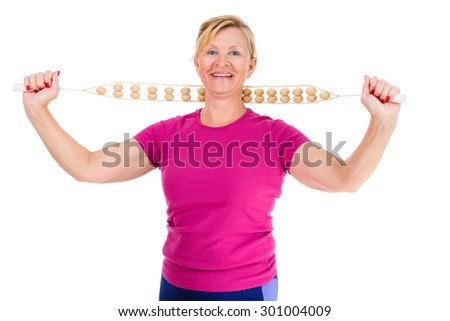 Happy and smile old senior woman dressed in t-shirt color Marsala doing sport fitness exercises with manual wooden masseur for massage of a neck, isolated on white background, Positive emotions
