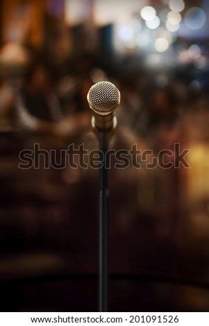 microphone in concert hall or conference room on a dark background