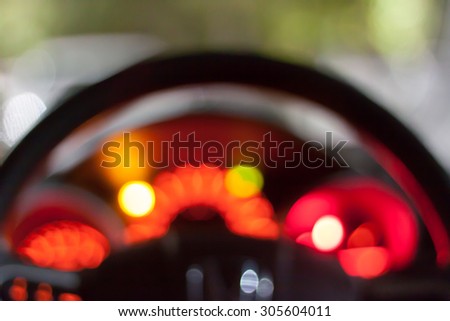 Abstract bokeh of car speed meter light dashboard with traffic light