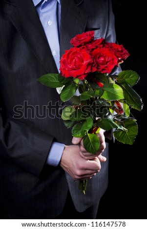 man gives a bouquet of red roses