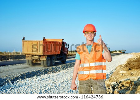 engineering construction company, building a new road construction in overalls