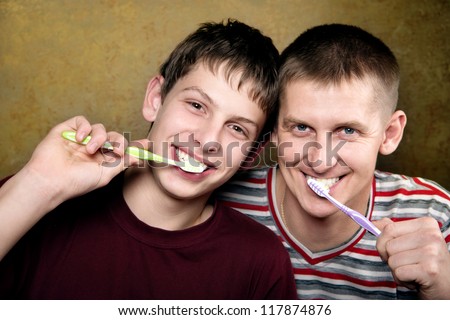 Dad and son brushing their teeth,,hygienic teeth cleaning every day,