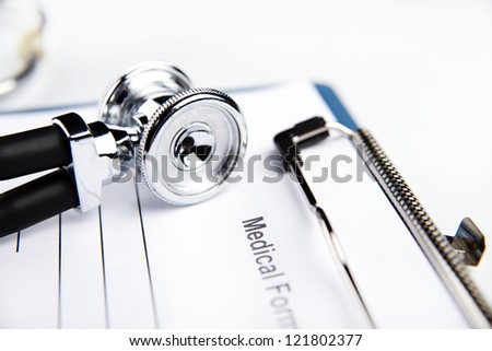 medical records, stethoscope and writing pen on the white table