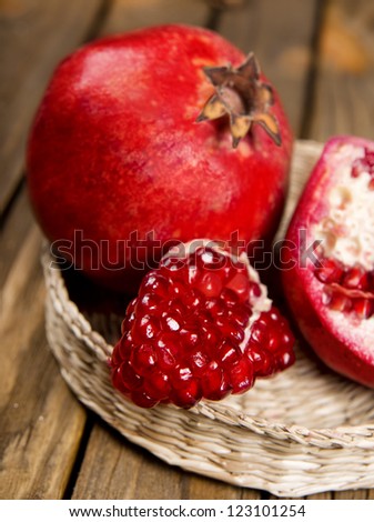 Pomegranate fruit on the table, sliced, pomegranate on a plate, peel a pomegranate,