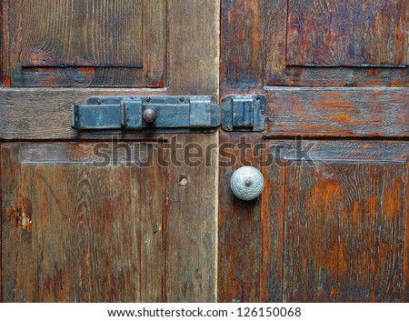 door closed and bolted.Closed old wooden door bolt lock