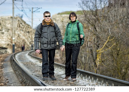 Two tourists go by rail