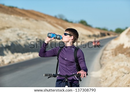 A cyclist rides on the road, traveling by bike, active in the fresh air, looking into the distance cyclist.