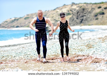 A couple in love runs along the sea.  Leisure activities on the shore of the Mediterranean Sea.