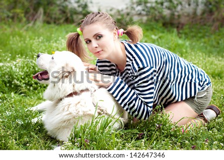Cheerful girl with a big dog. Girl walking with a dog
